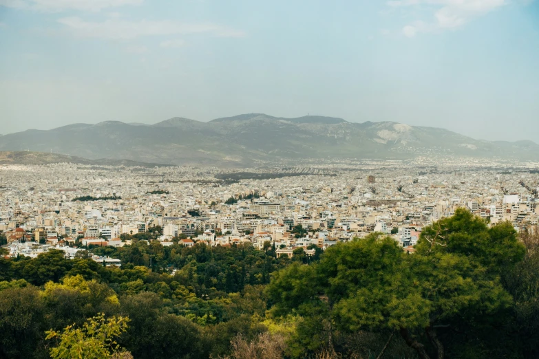 an image of a city with trees and hills