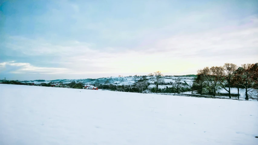 a man standing in a snow covered field on skis