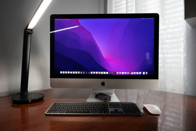 the screen is on a table in front of a keyboard and mouse