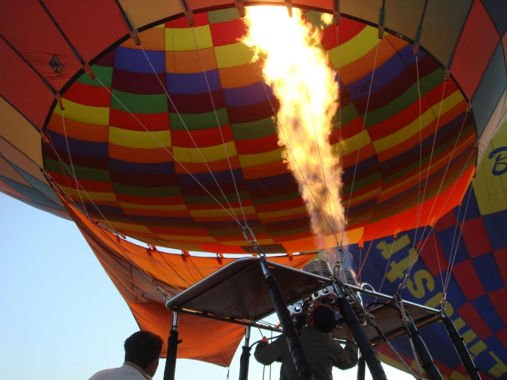 a man in black jacket pouring water into  air balloons