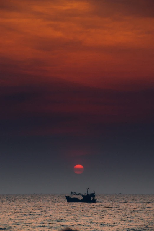 a red and orange sunset over the ocean