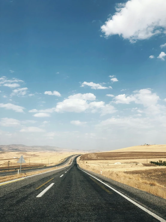 the road looks deserted as it heads toward the horizon