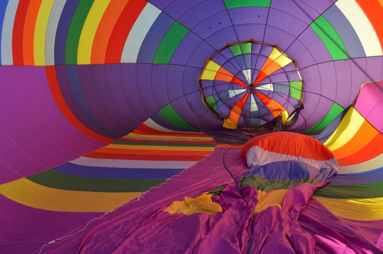 colorful air balloons are inside a large, open room