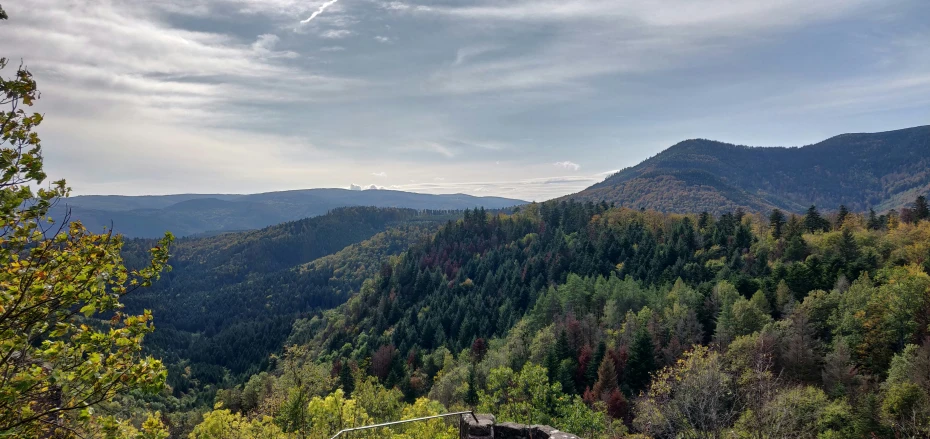 a scenic po looking down into a mountainous valley with trees and hills