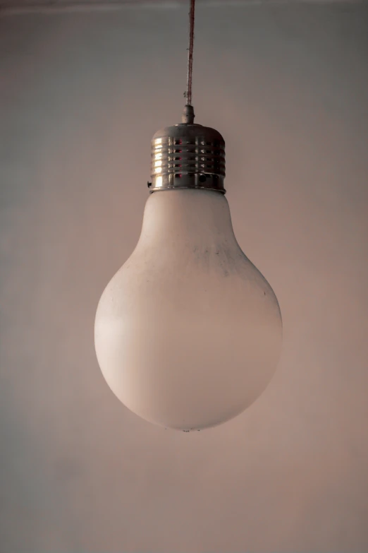 a white light bulb that is hanging in the air