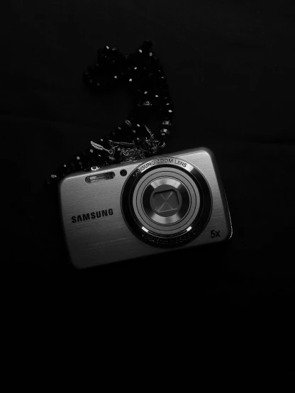 black and white po of a camera on black cloth