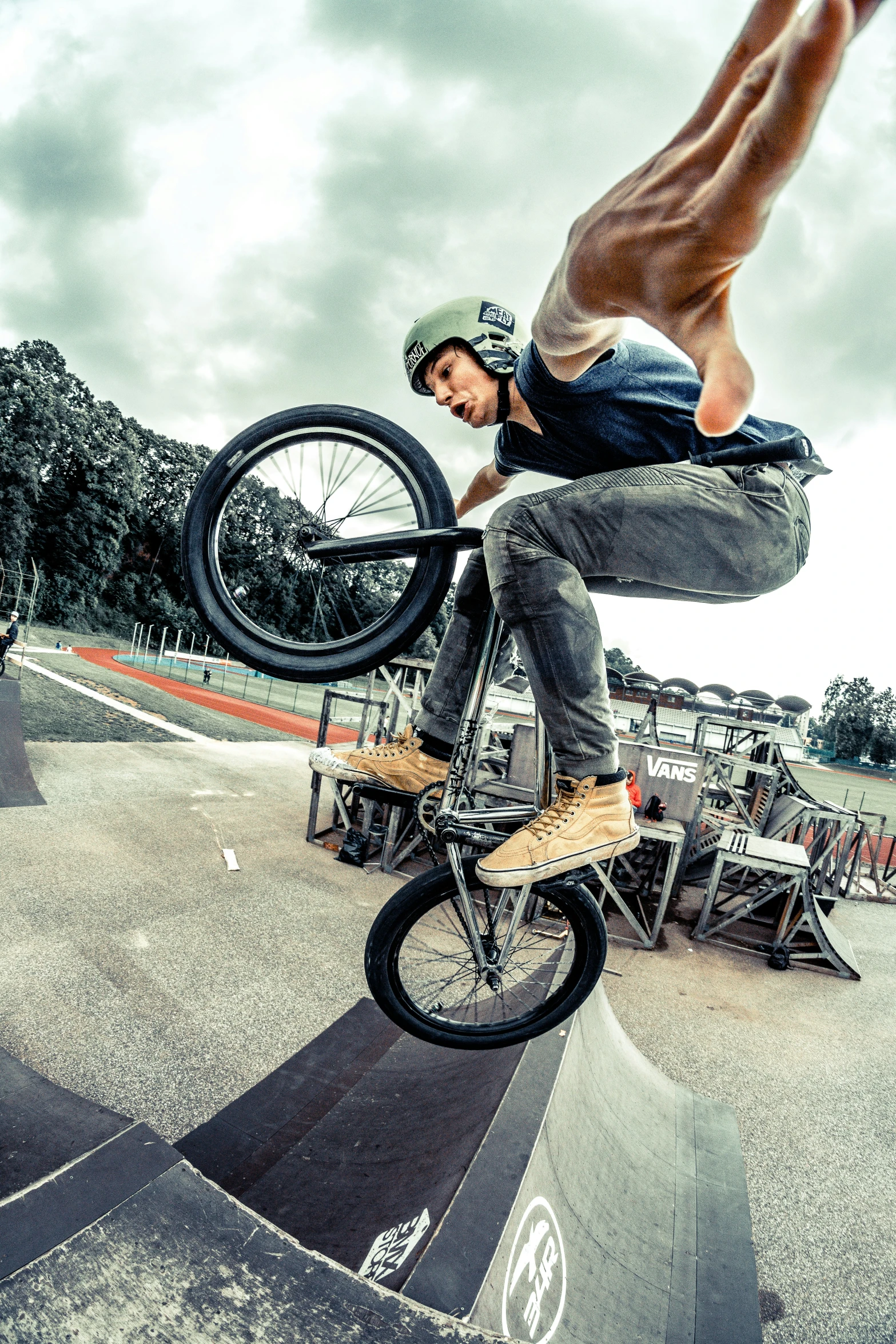 a man on a bike doing tricks on a ramp