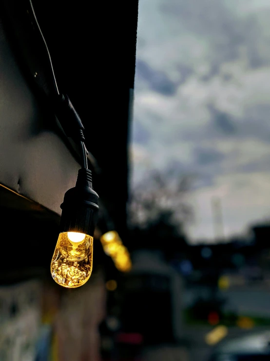 a yellow light is hanging from a wire