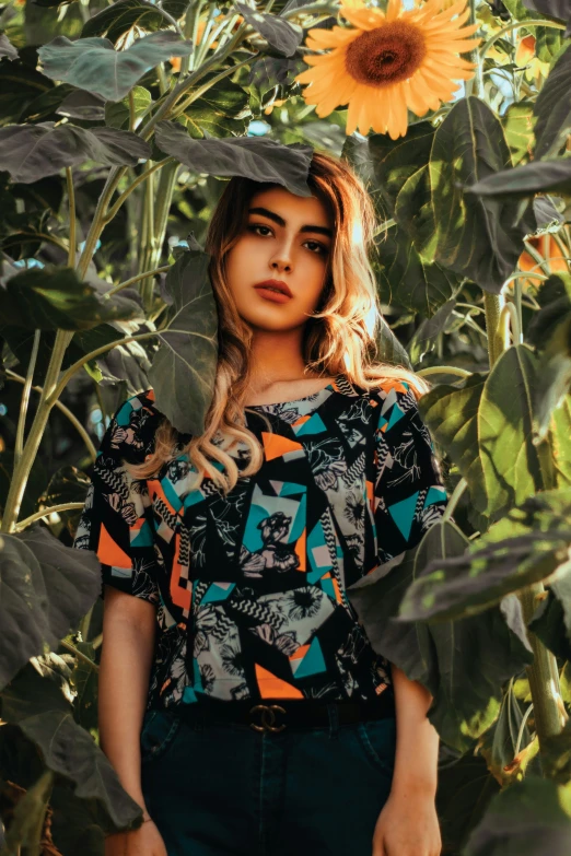 a woman is wearing a colorful shirt standing in a tree