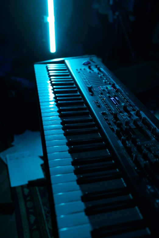 a glowing computer keyboard on a desk next to a person