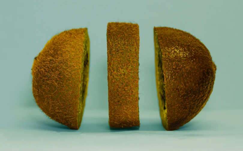 two slices of fruit that are gold colored