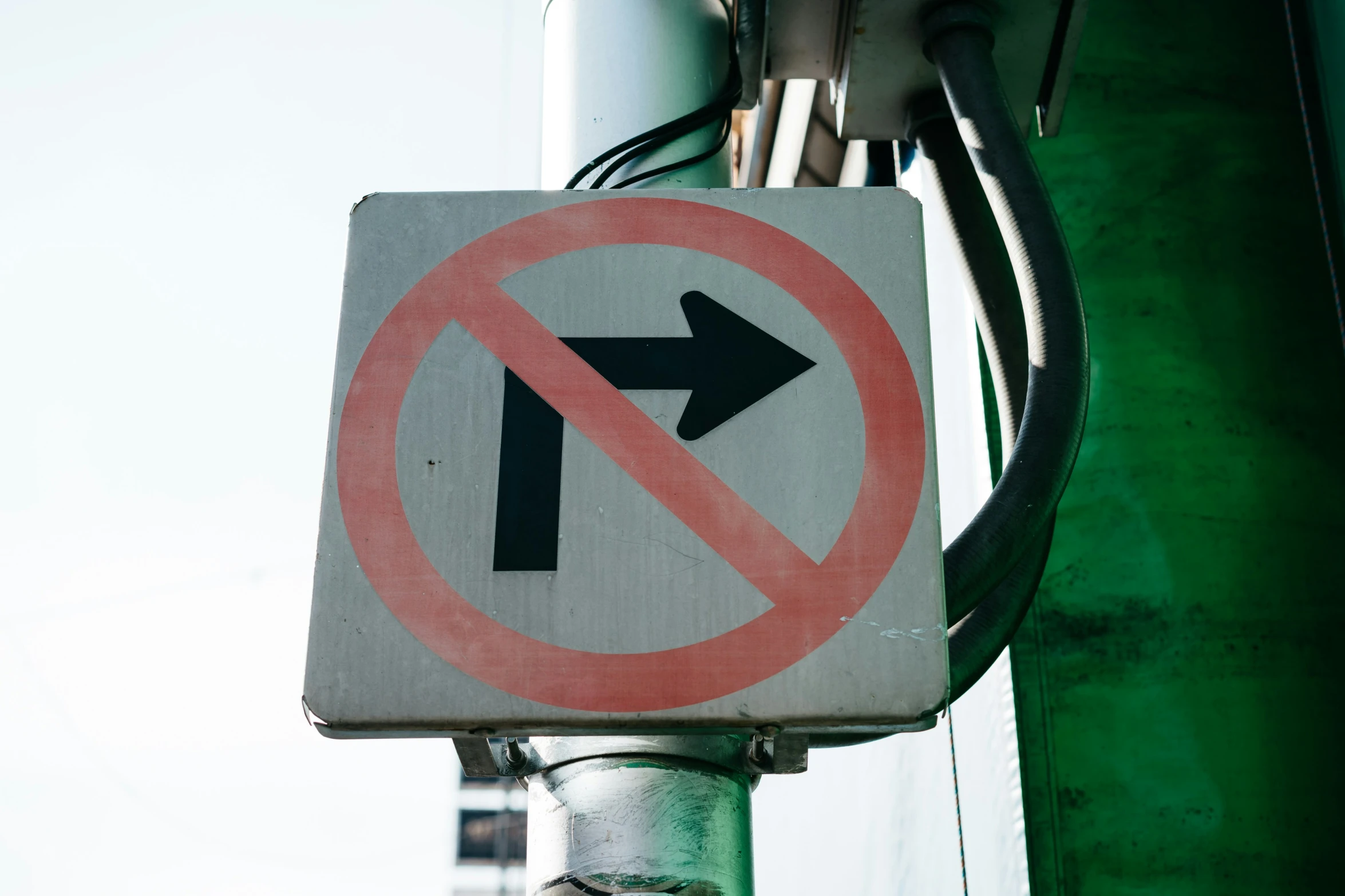 a no right turn sign hanging from a pole