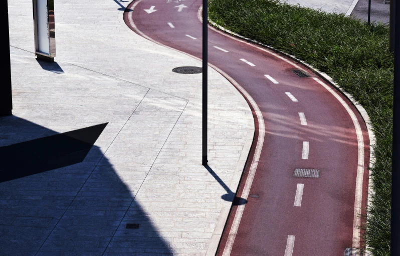 an aerial s of a city street and a curved sidewalk