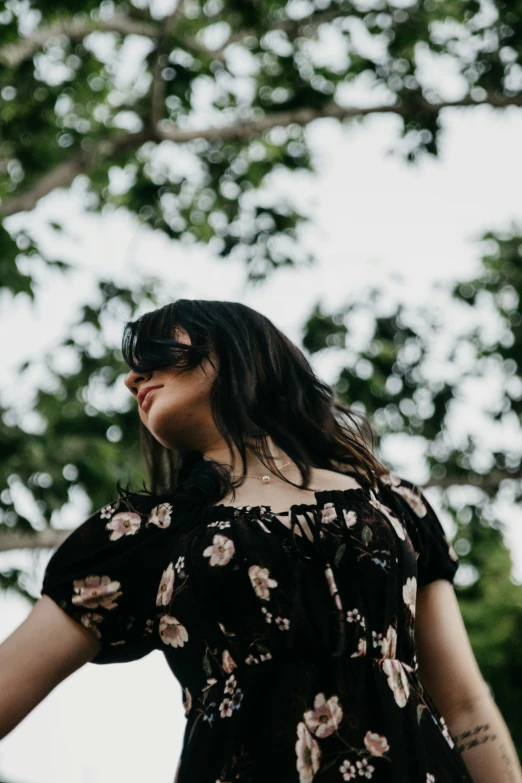 a woman with glasses that is looking up in the air