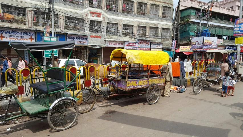 several bicycles and two carts for transporting goods on street