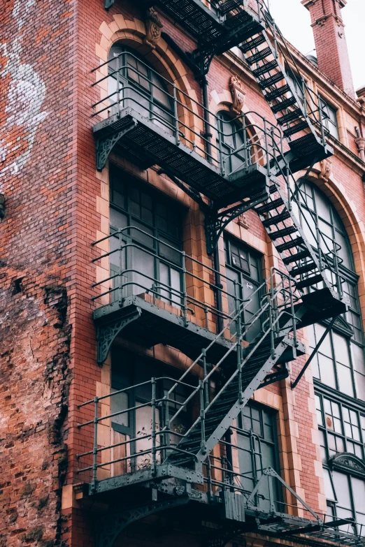 a very tall building with lots of stairs going up it's side