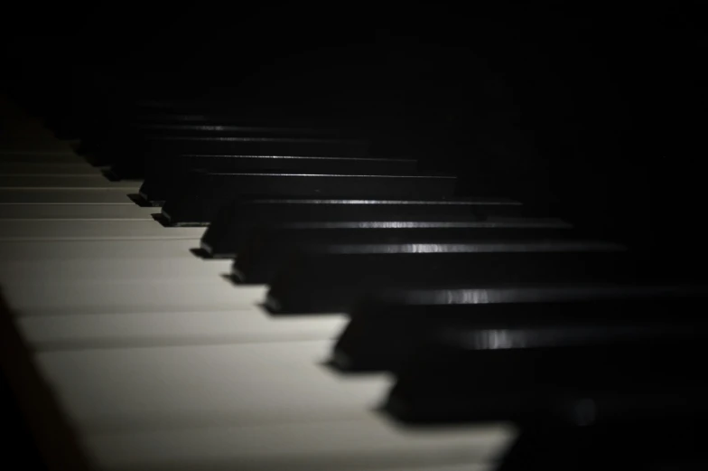 a close up view of piano keys as they are dark