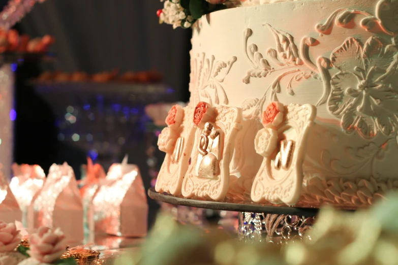 a wedding cake is decorated with orange sugar roses