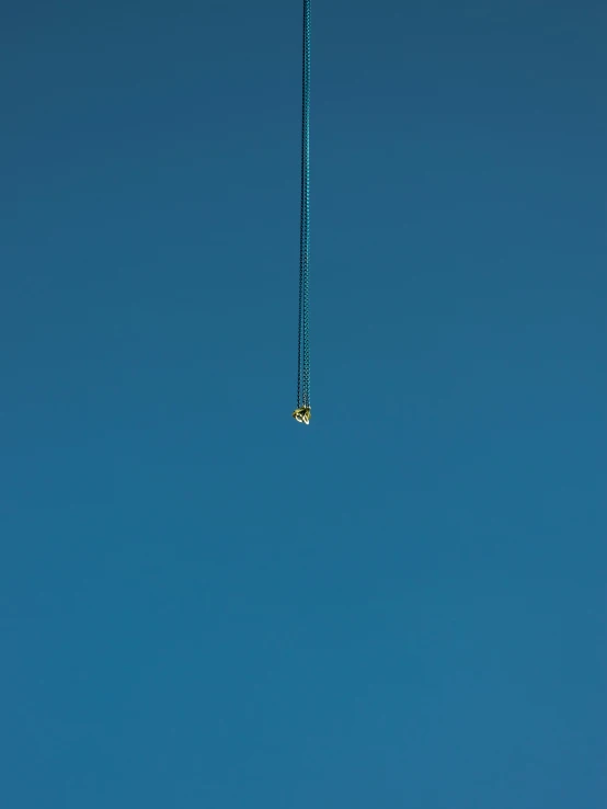 a kite flying high up in the sky