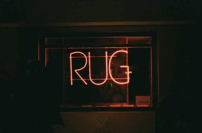 a dark room with neon lights on it and a rung neon sign