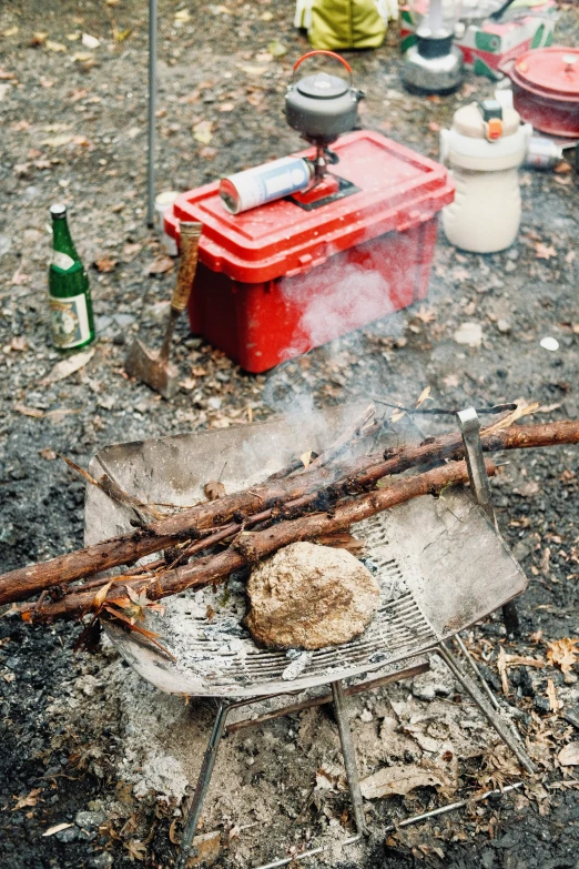 a dirty pot and food fryer in the grass