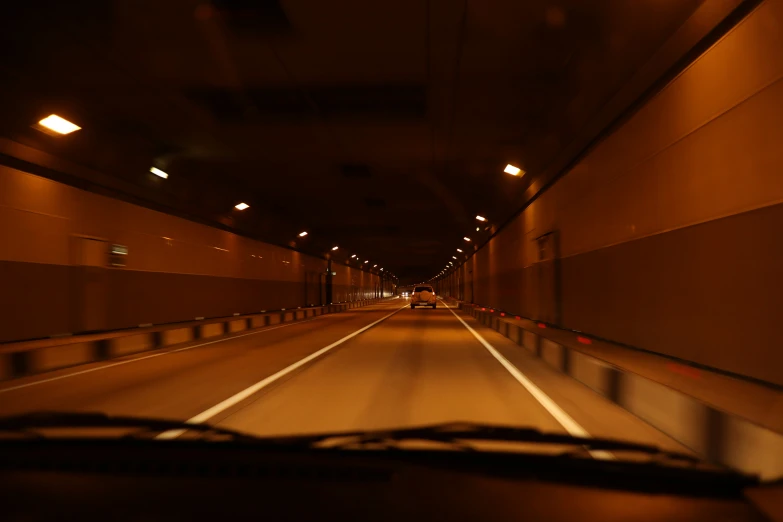 a dimly lit tunnel going down the middle of a road