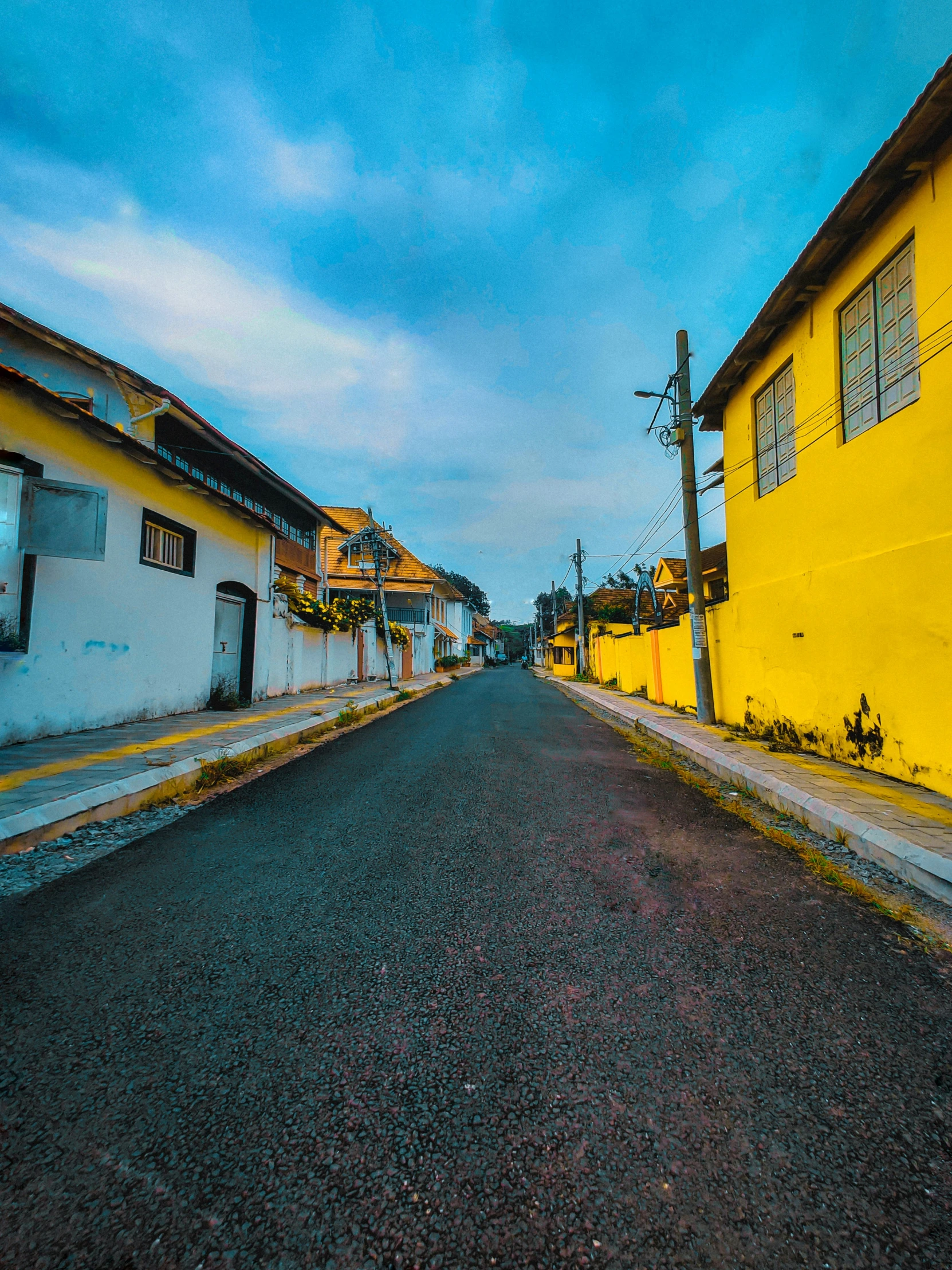 a road in a neighborhood with yellow and black buildings