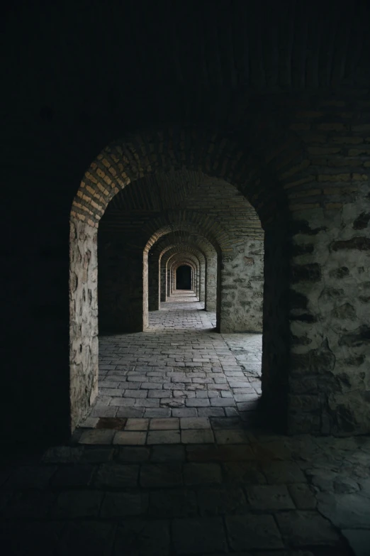 a dark tunnel between two concrete walls