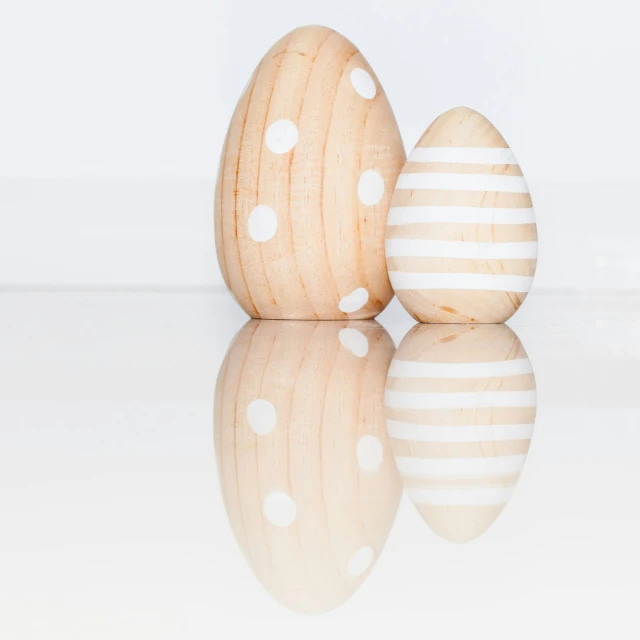 two wooden eggs with one egg in between them