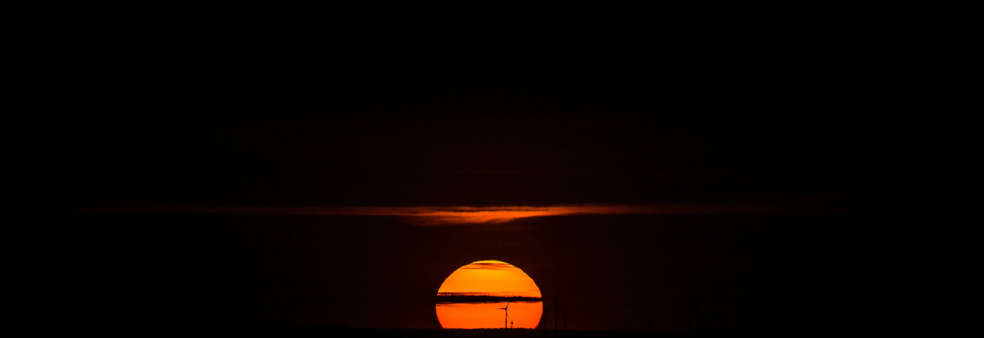 the sun is setting over a body of water