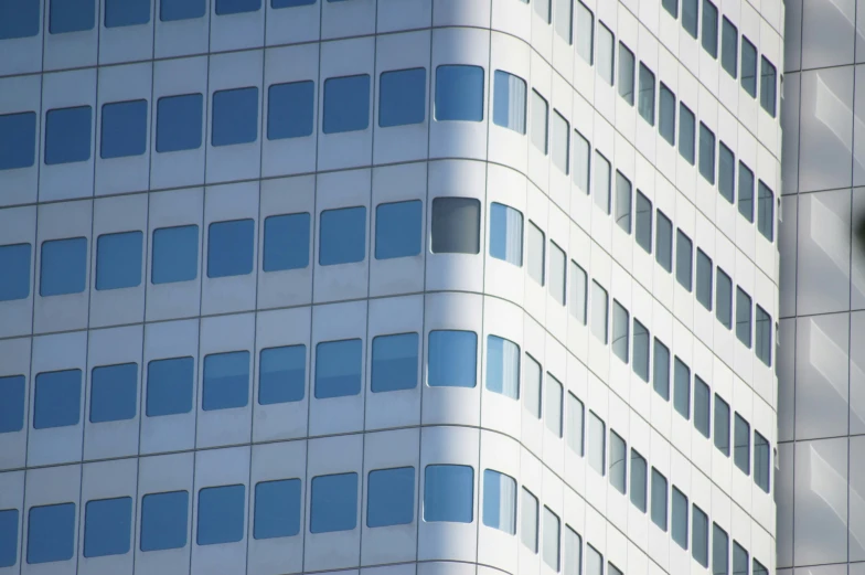 the corner of a building, with some windows and an arch