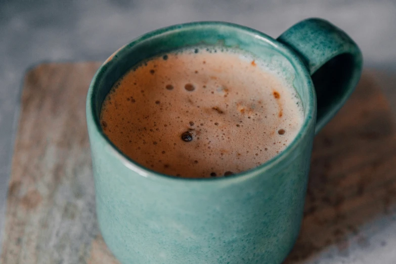 a cup of  chocolate sitting on top of a plate