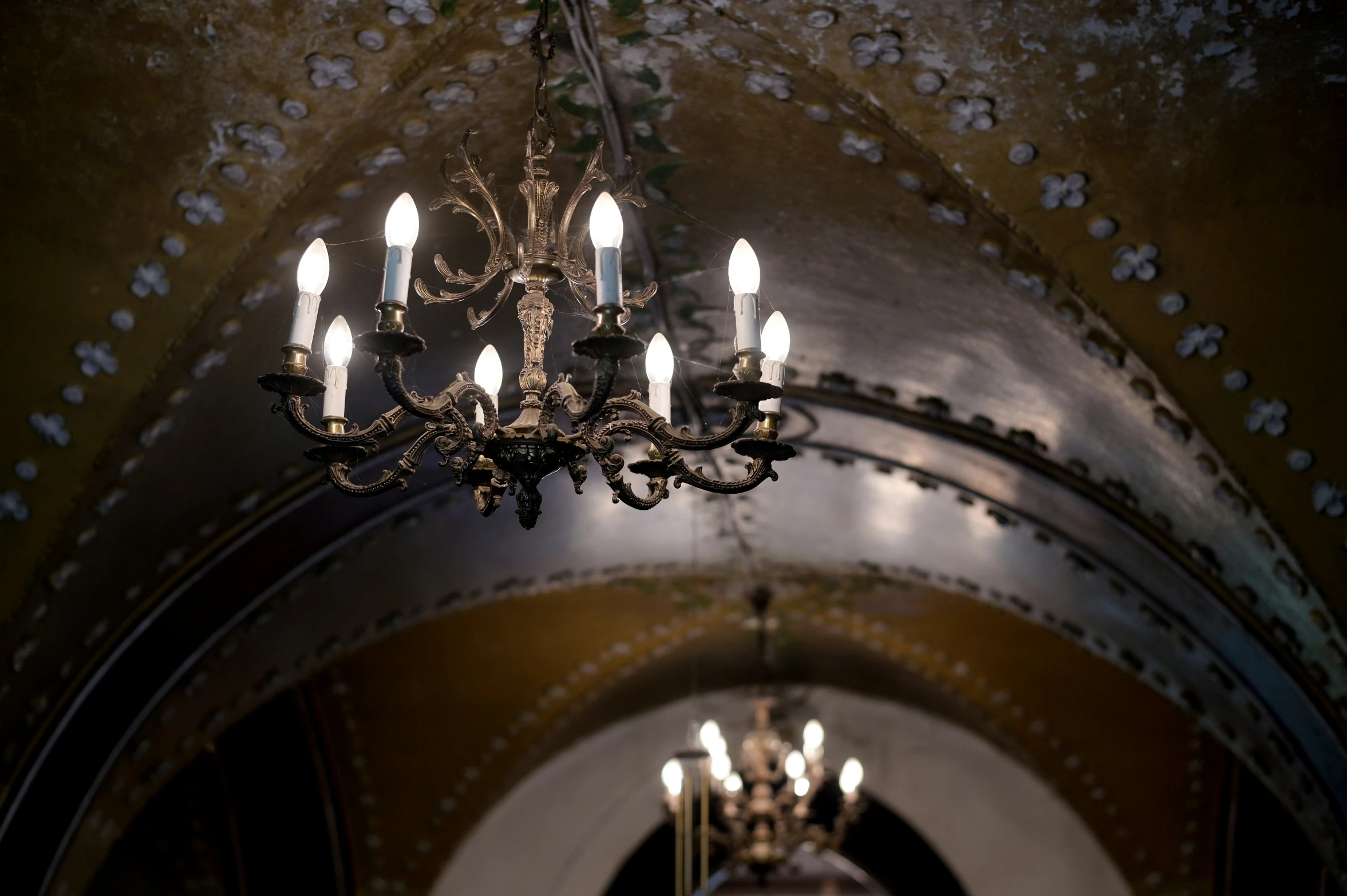 a chandelier hanging from the ceiling inside a building