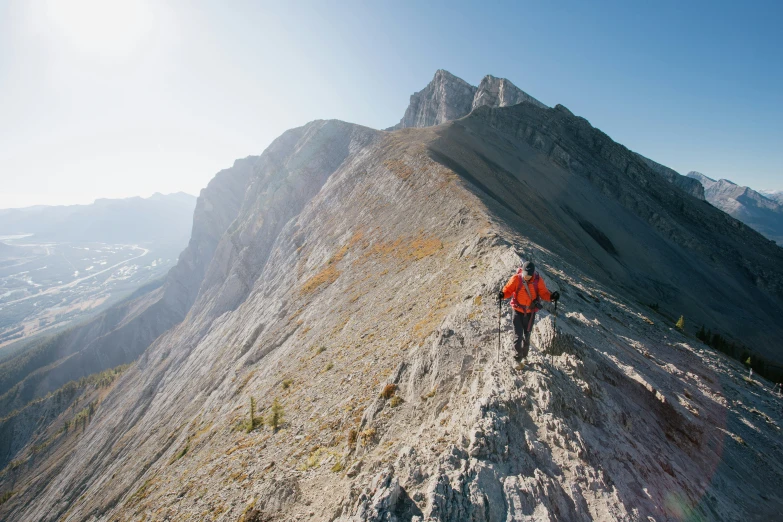 a person is walking up the side of a mountain