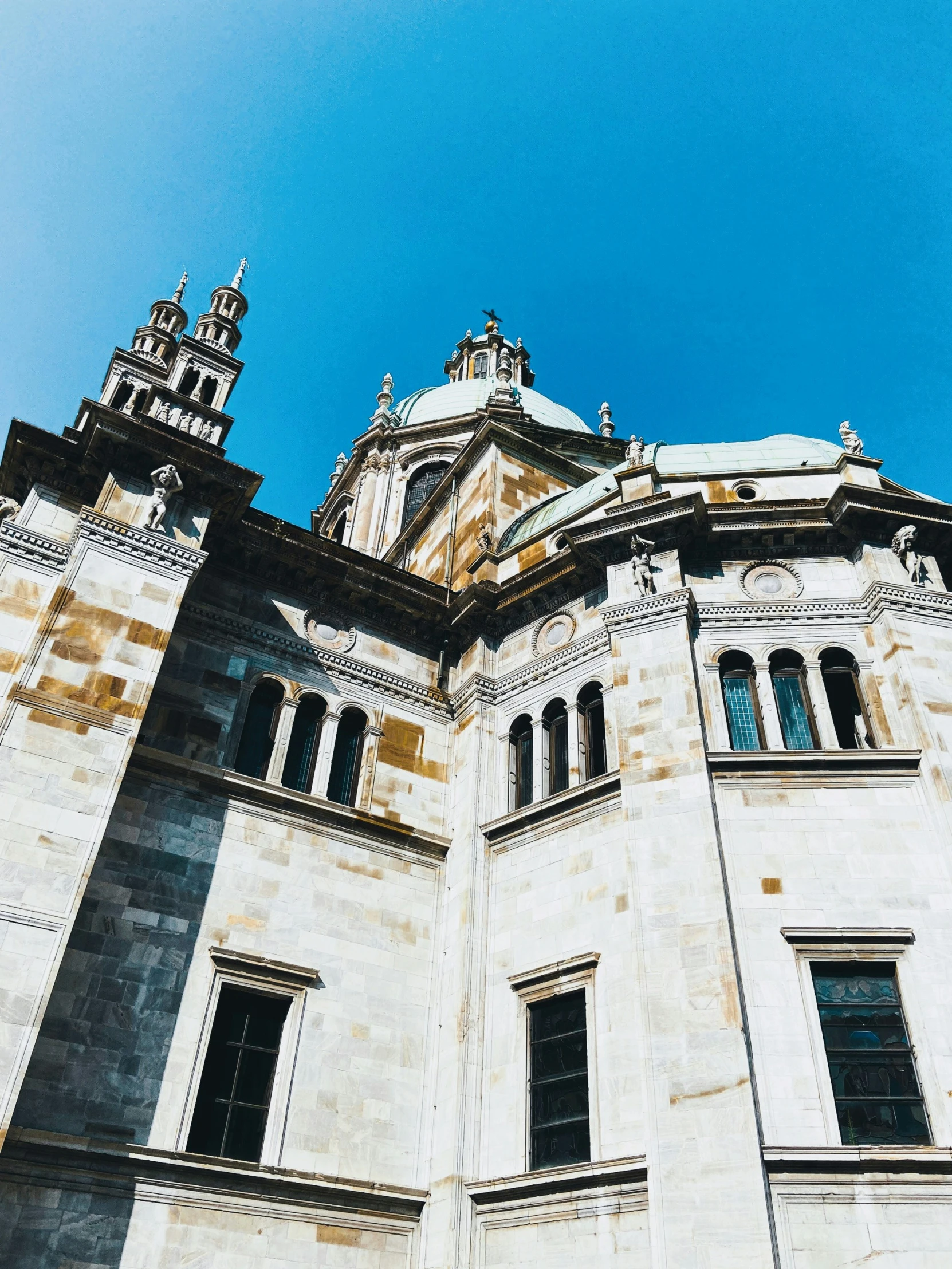 the top of an old white castle with a clock tower