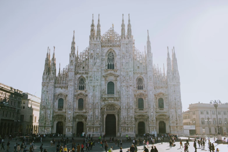 large cathedral near the city with lots of people walking around