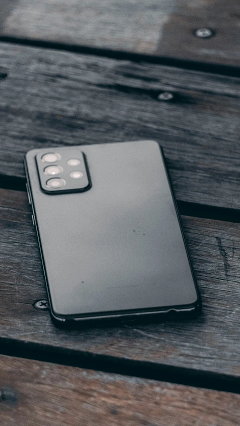 a cell phone on a wooden bench in the dark