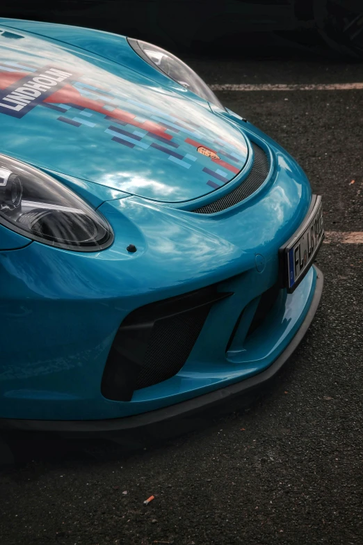 a blue sports car is parked on a street