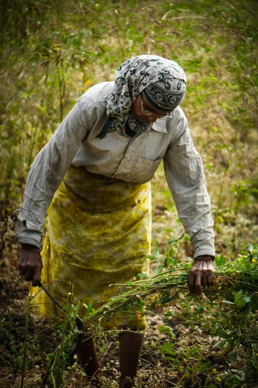 a woman carrying soing in the grass in a grassy area