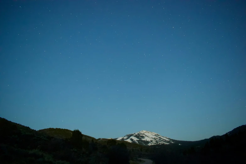 an image of night sky over the mountain