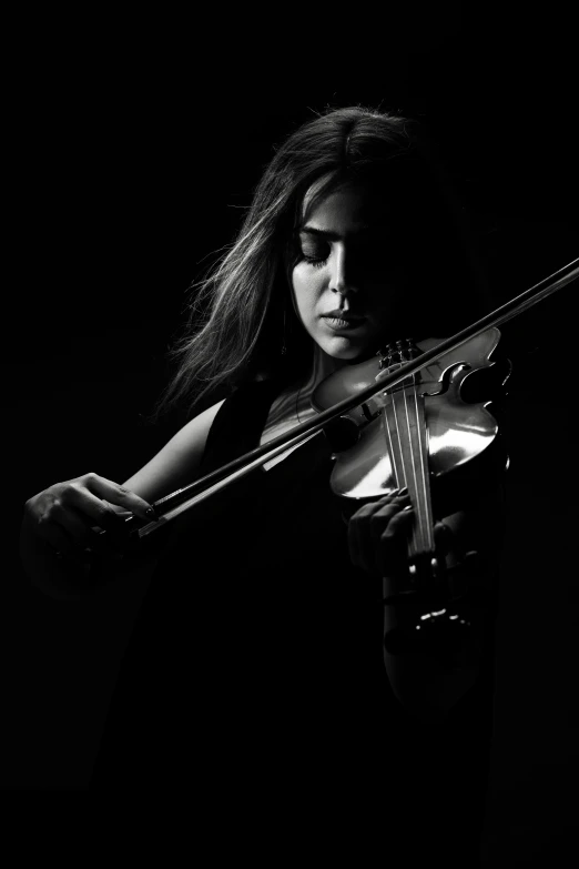 a  holding the violin in her hands