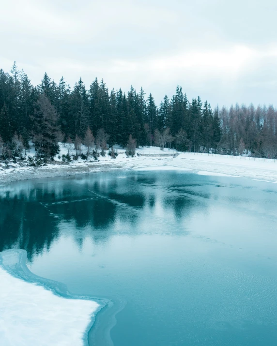 there is a beautiful lake in a snowy area