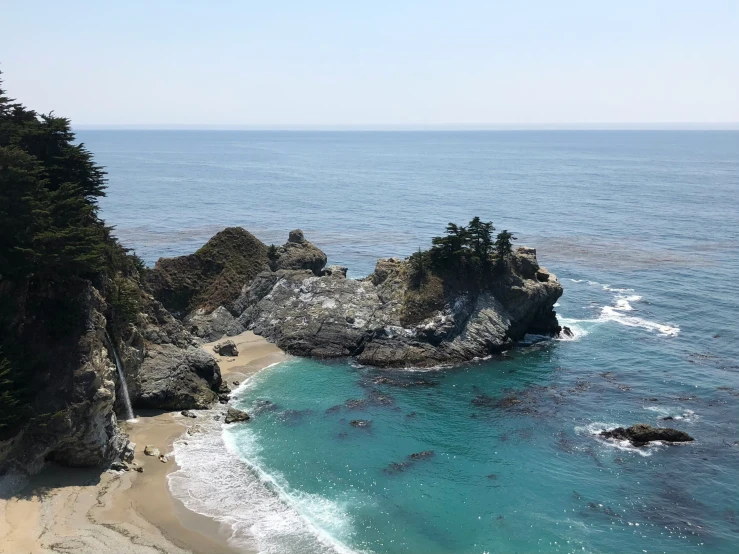 an image of a beautiful blue beach with the shoreline