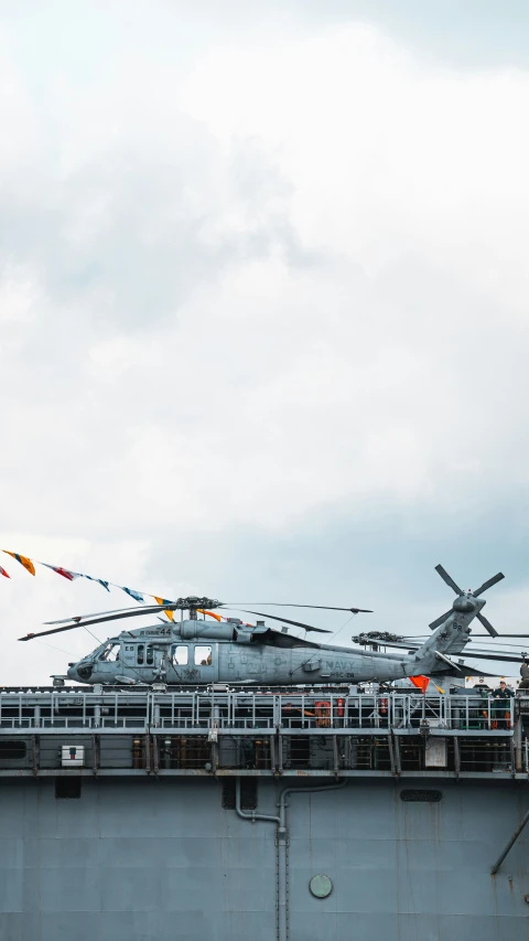 several military ships on a ship in the water