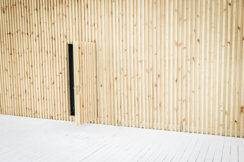 a very long white floor with the wall made of wood