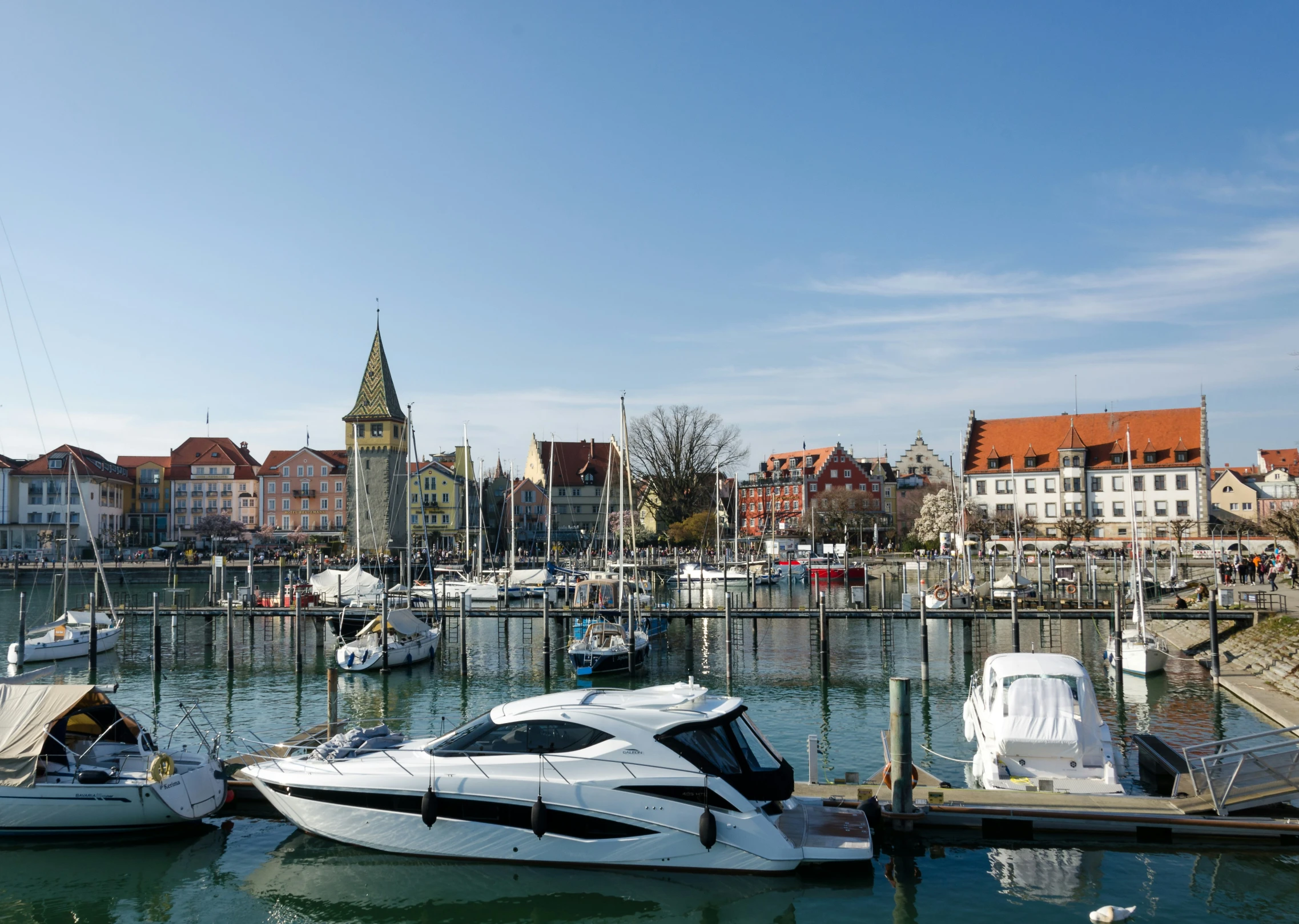 several boats docked in the water in front of a dock