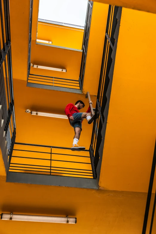 there is a male on a yellow wall that has stairs