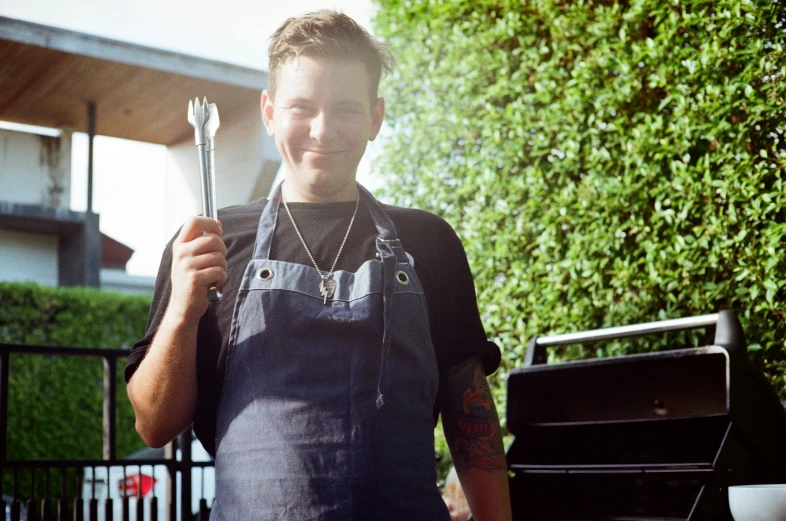 man holding two cooking utensils in his hand