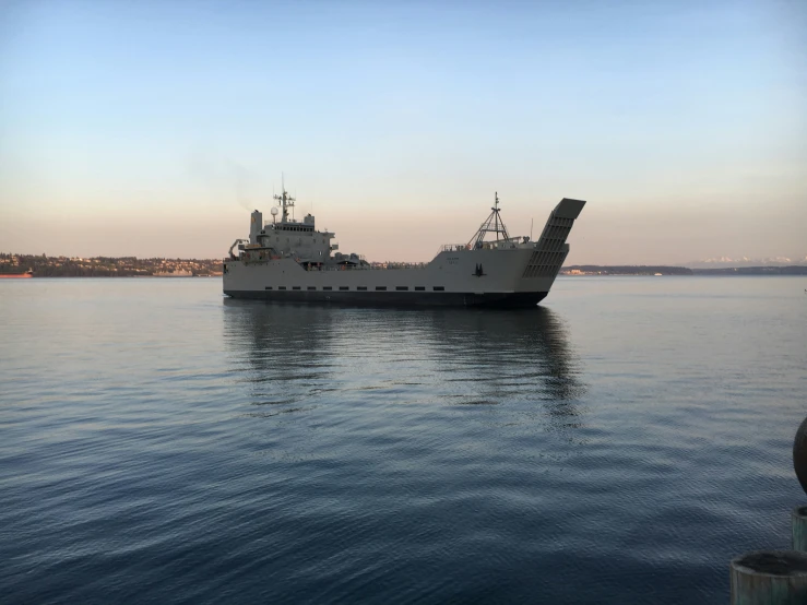 two boats in water next to each other with the sky