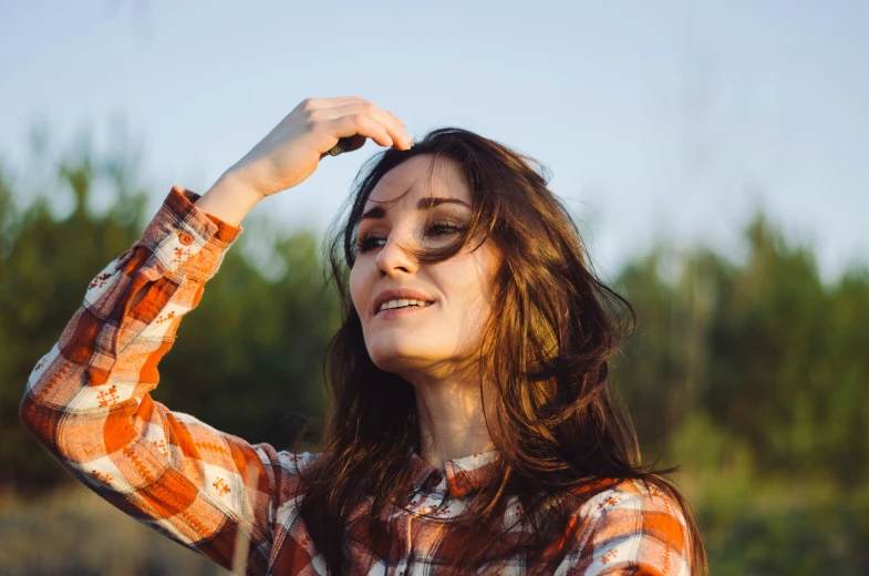 the woman is wearing a shirt with floral prints